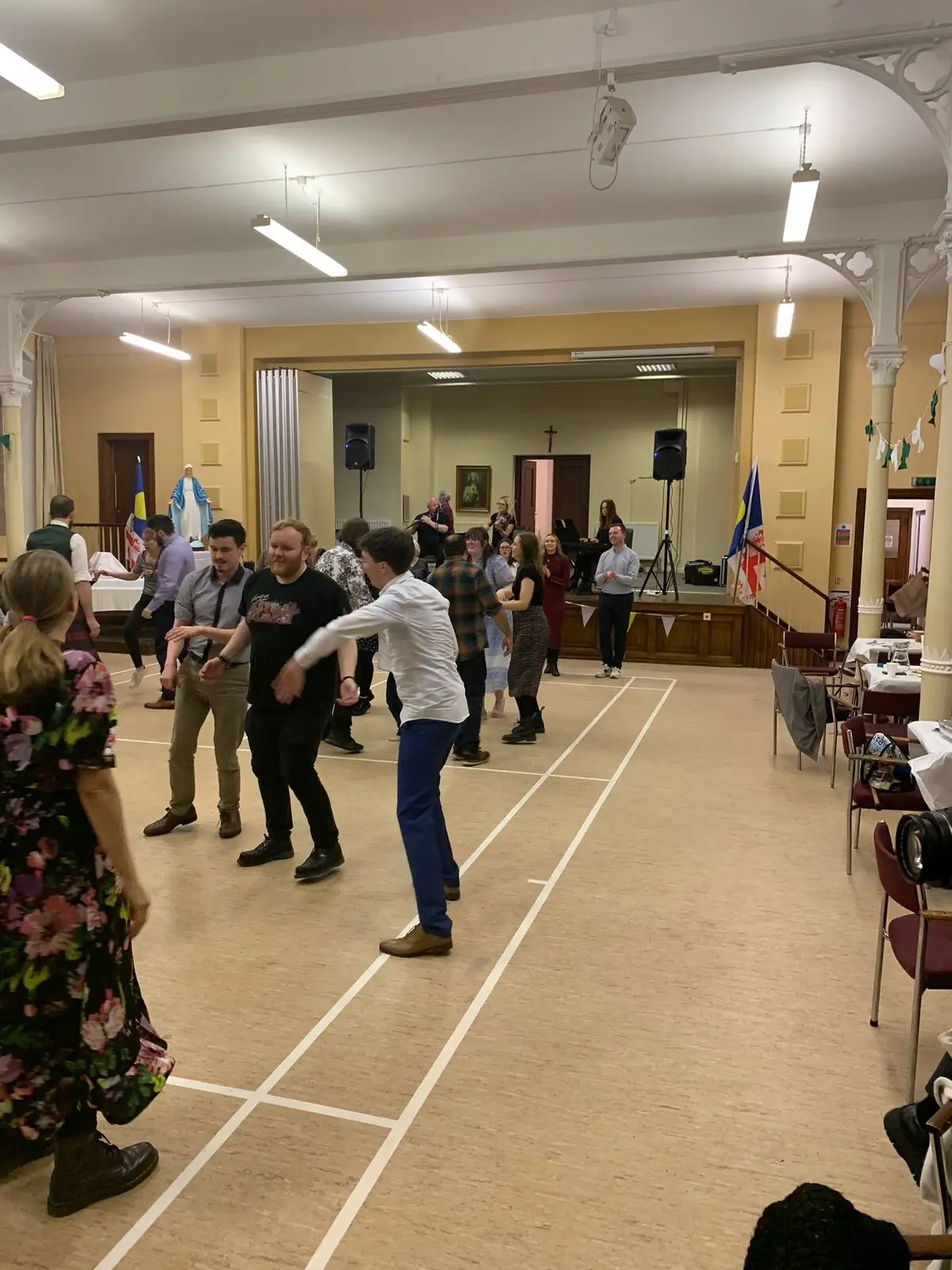 Dance hall with Our Lady statue and band