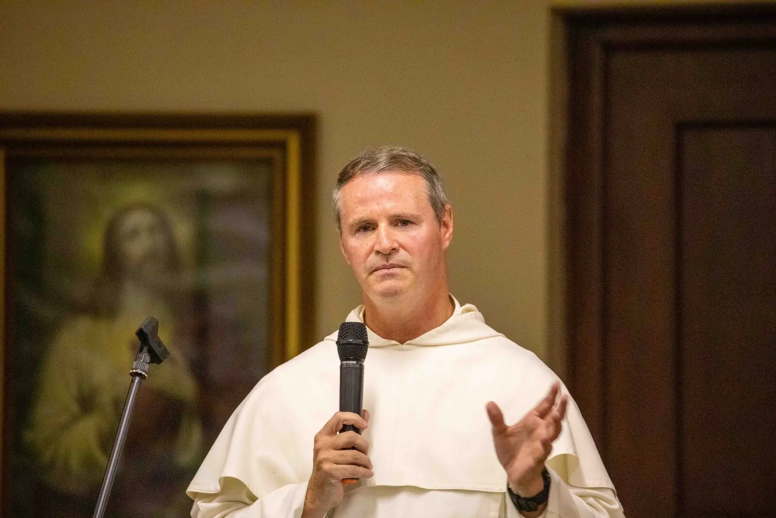 Priest speaking at the event