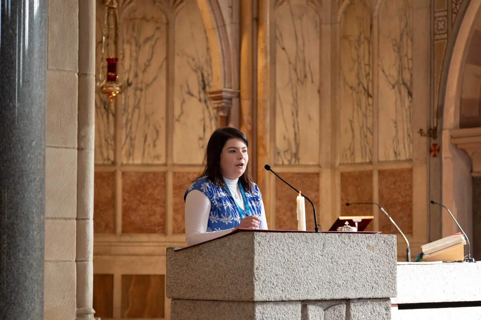 Young woman reading at the lectern